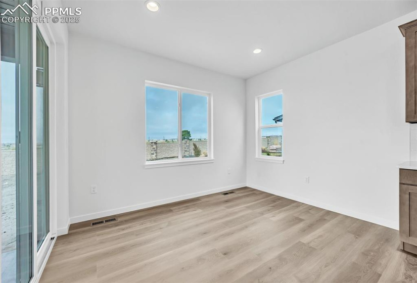 Unfurnished room with baseboards, light wood-style flooring, visible vents, and recessed lighting