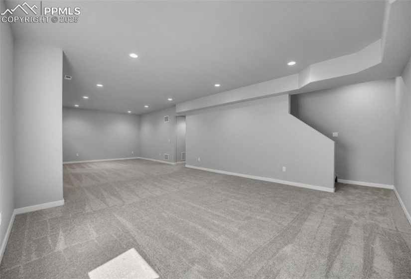 Finished basement with carpet floors, recessed lighting, and baseboards