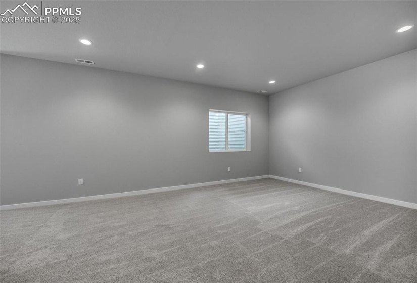 Spare room featuring recessed lighting, carpet, and baseboards